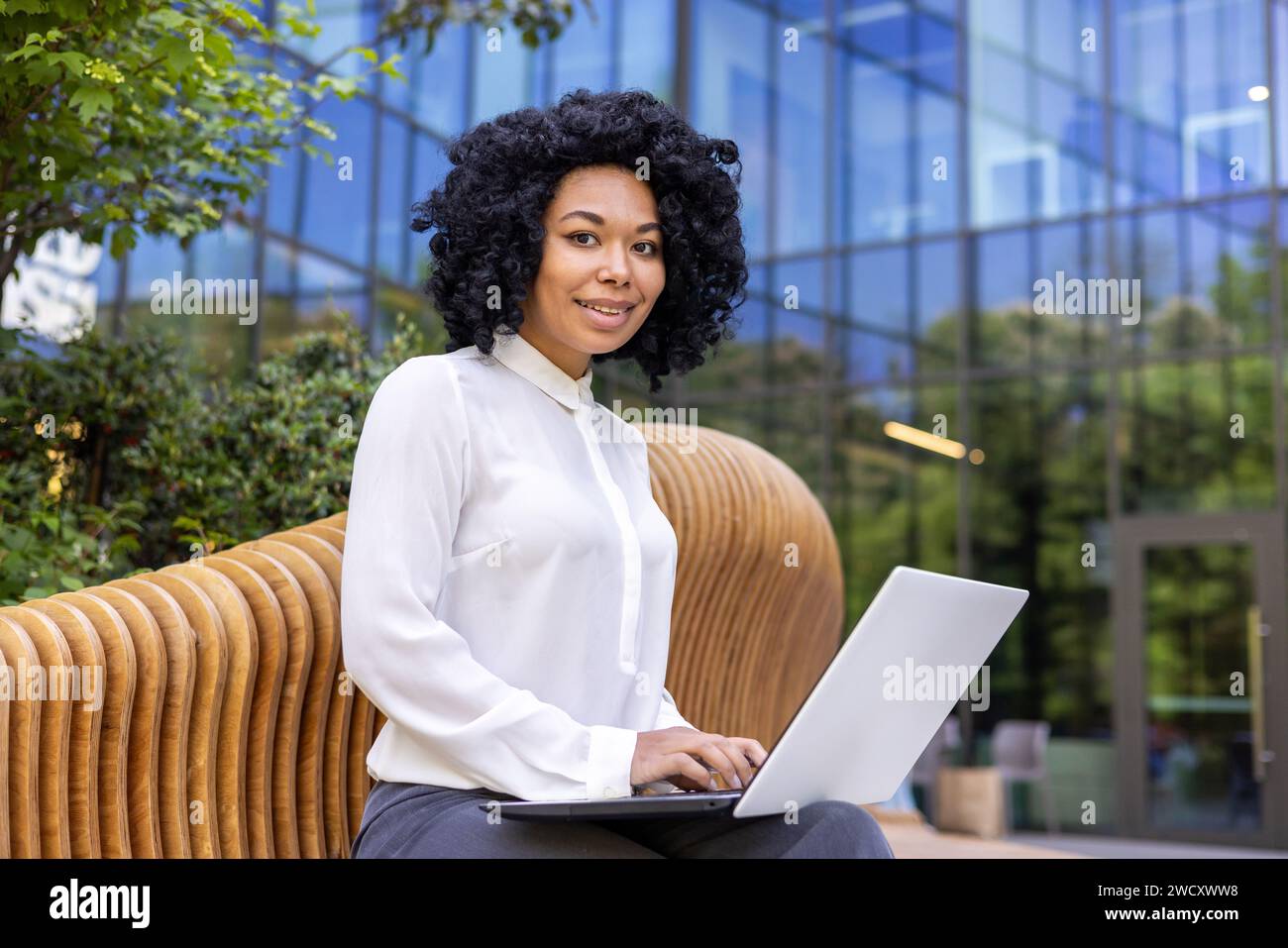 Portrait of a young African American businesswoman sitting outside an ...