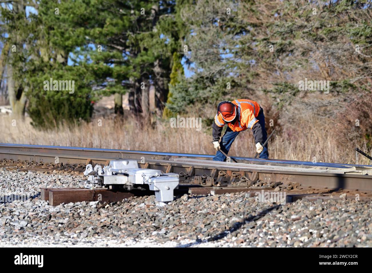 Hinckley, Illinois, USA. A railroad worker working on switch points at a siding in rural Illinois on the Burlington Northern Santa Fe Railway. Stock Photo