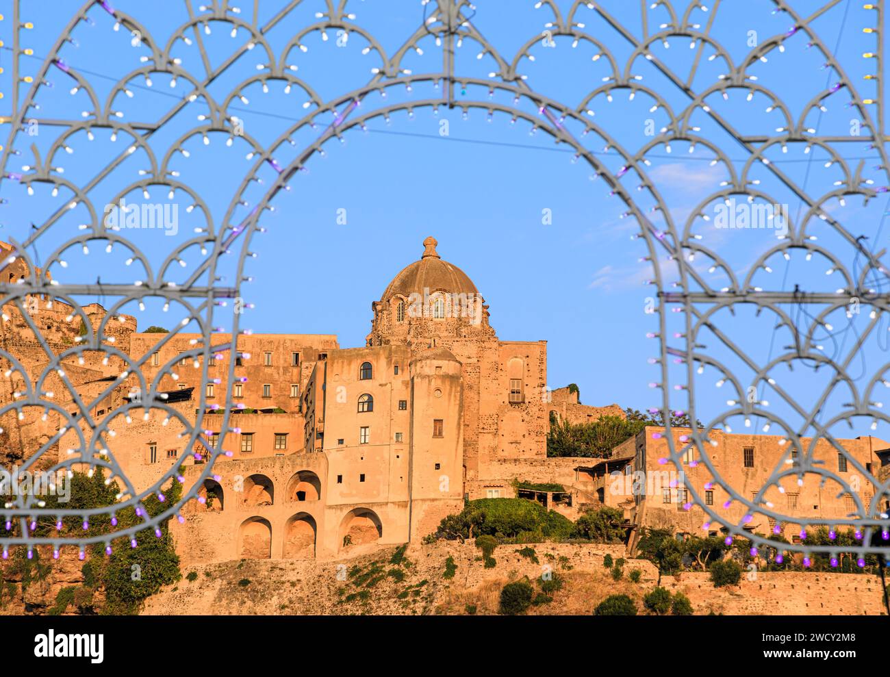 Glimpse of the Aragonese Castle in Ischia Ponte town among lights for the patron saint's day, Italy. Stock Photo