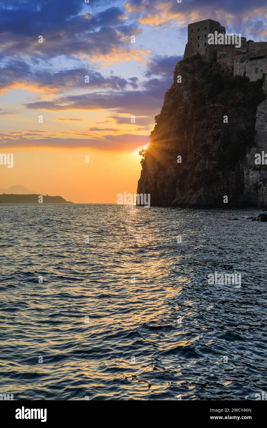Sunrise view of Ischia Island, italy.Iconic view of the island of Ischia: glimpse of the Aragonese Castle at dawn in Ischia Ponte. Stock Photo