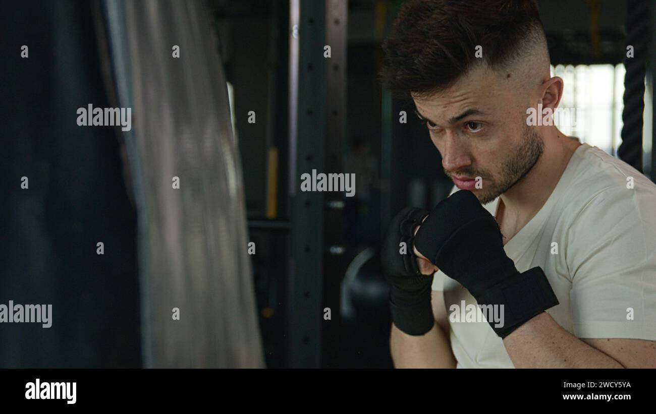 Active motivated sportsman male professional fighter boxer training