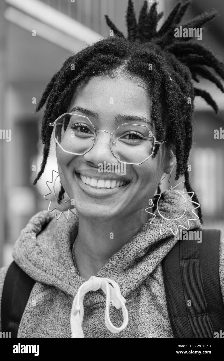 Beautiful african american woman, face close up, teeth smile, happy positive. Happy young african american woman smiling looking into camera. Outdoor Stock Photo