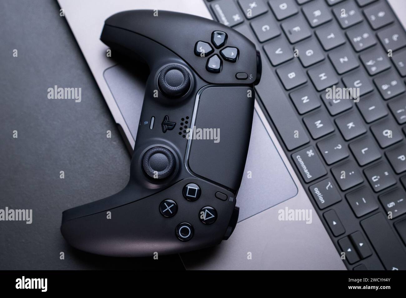BERLIN , GERMANY - JANUARY 14 2024: Detailed photo capturing the close proximity of a video game controller and a keyboard. Stock Photo