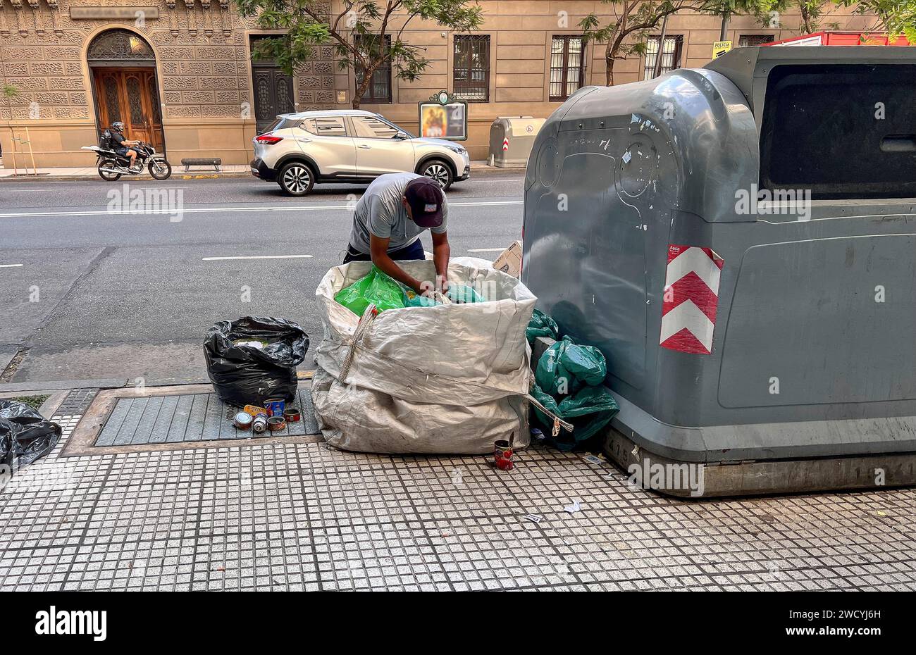 Trash scavenger sorts rubbish on street in Buenos Aires, Argentina Stock Photo
