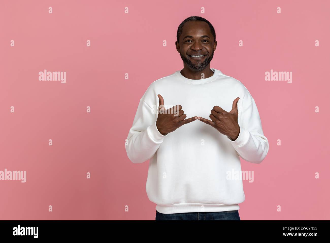 Black man wearing white sweatshirt using sign language Stock Photo