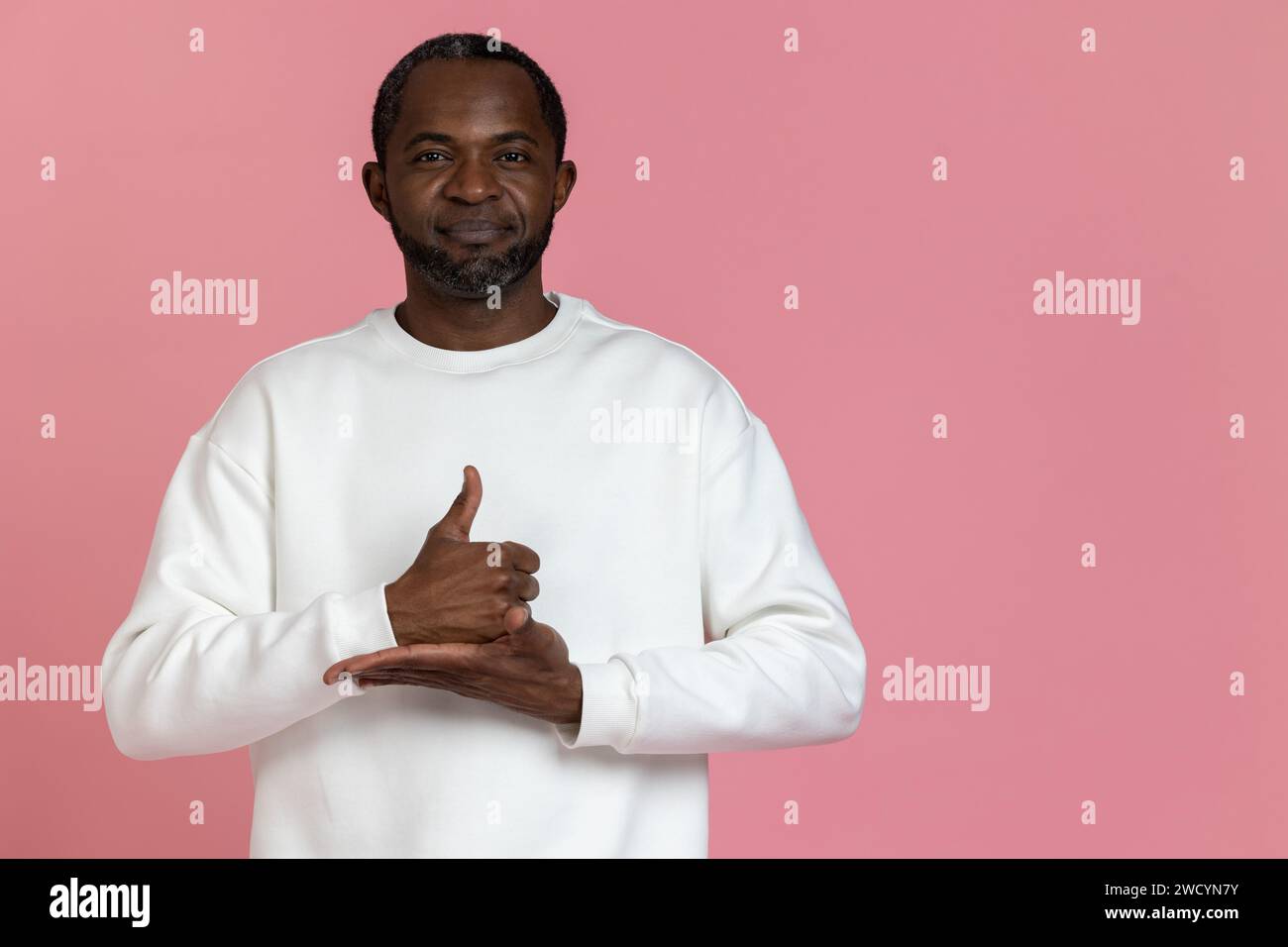 Black man wearing white sweatshirt using sign language Stock Photo