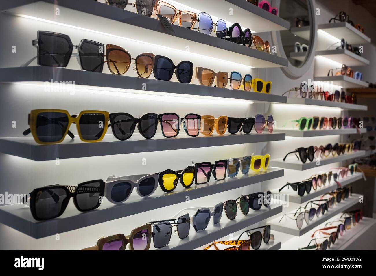Storefront shelves of various modern sunglasses in retail store. Display rack full of sunglasses. Stand with sunglasses. Fashionable Trendy sunglasses Stock Photo