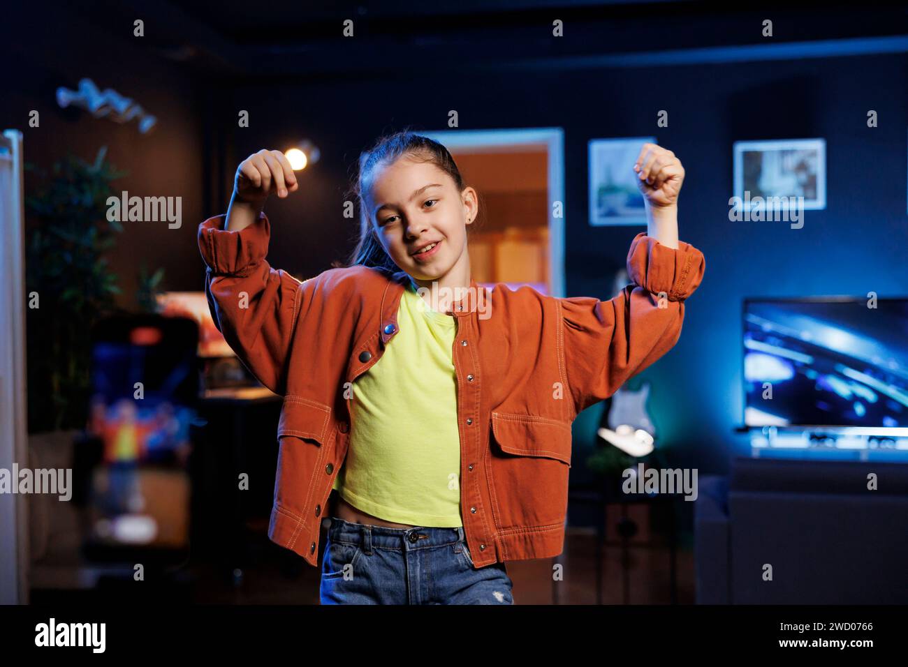 Entertaining kid in dimly lit personal studio joins viral dance craze