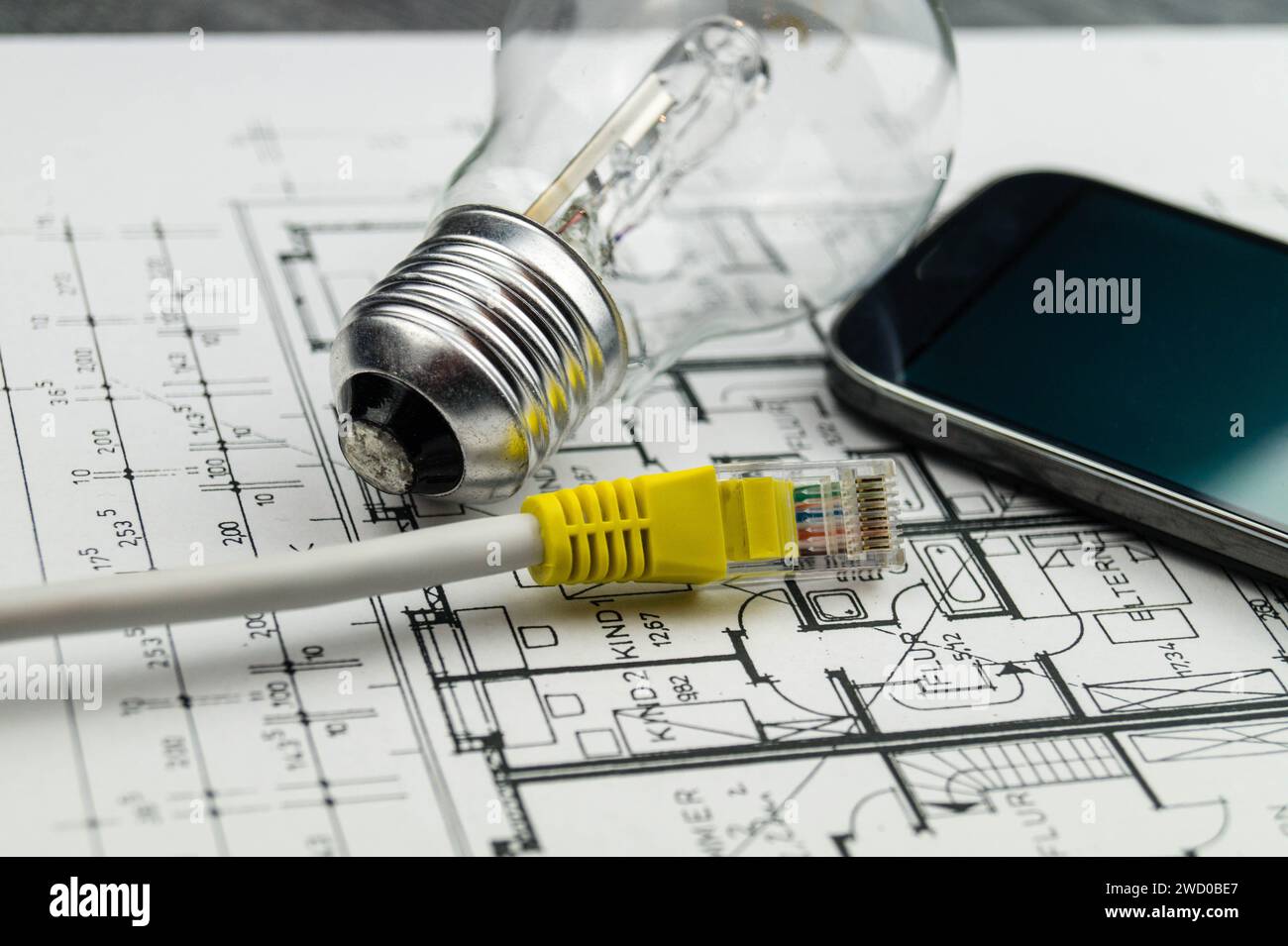 light bulb, network plug and smartphone on ground plan, symbolic image for smart home Stock Photo
