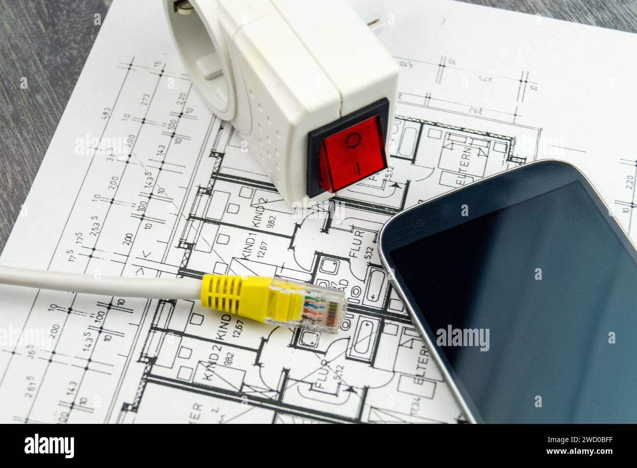 socket outlet adapter with switch, smartphone and network plug on construction drawing, symbolic image for Smart Home Stock Photo