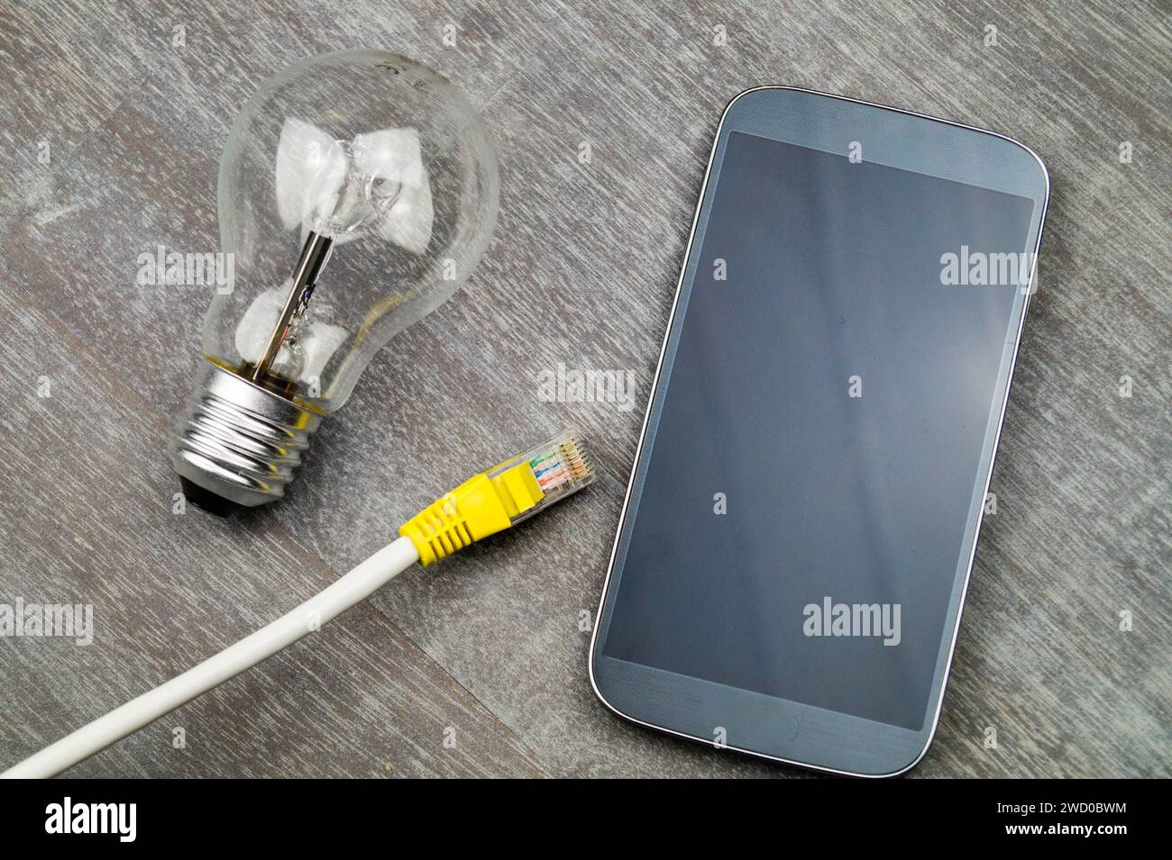 light bulb, network plug and smartphone, symbolic image for smart home Stock Photo