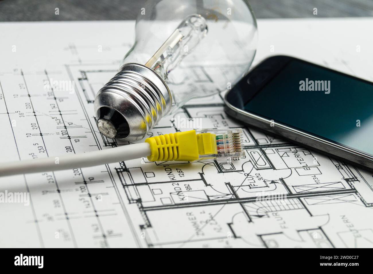 light bulb, network plug and smartphone on ground plan, symbolic image for smart home Stock Photo