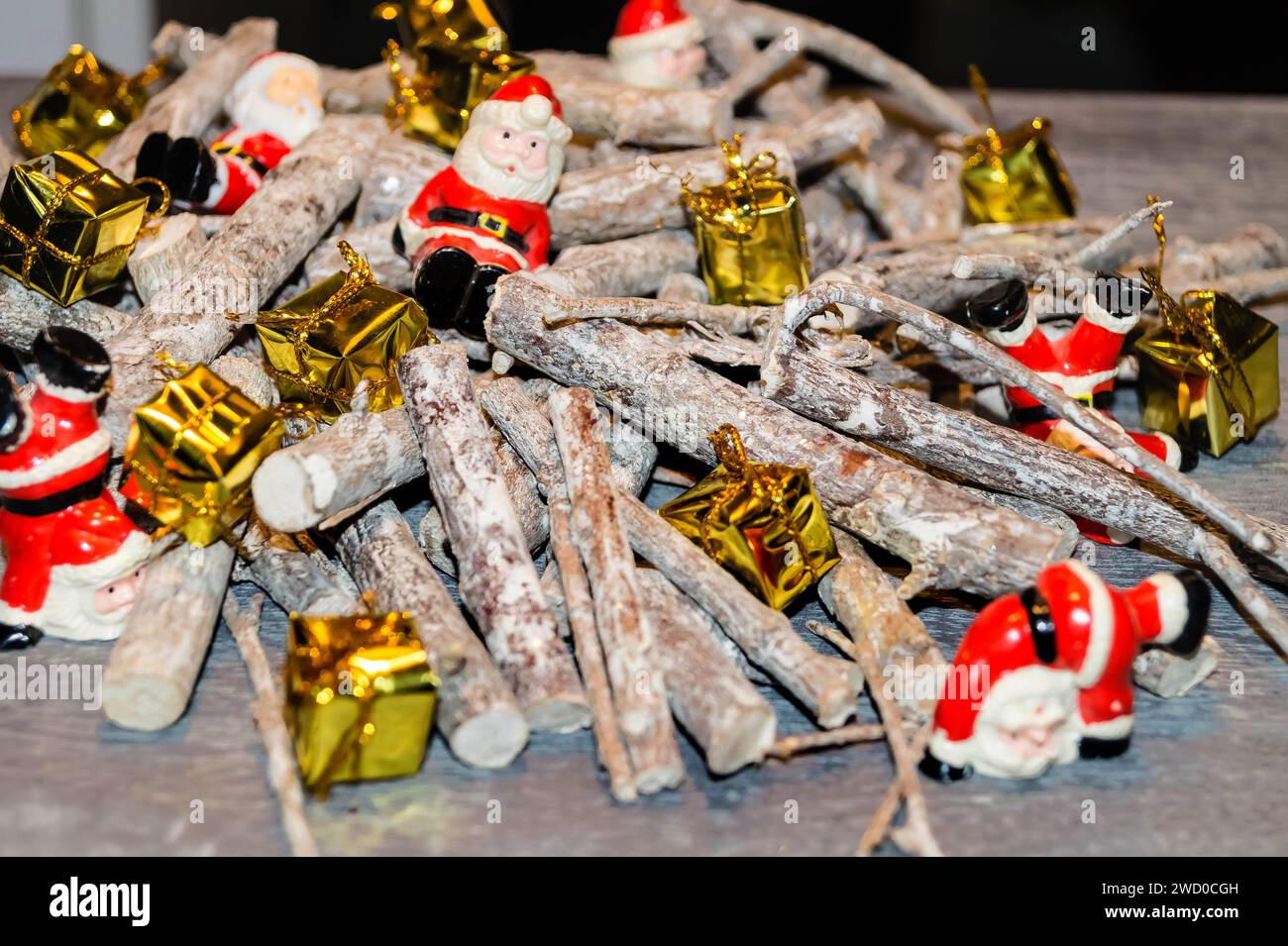 Christmas decorations made from sticks, Santas and presents on the table Stock Photo