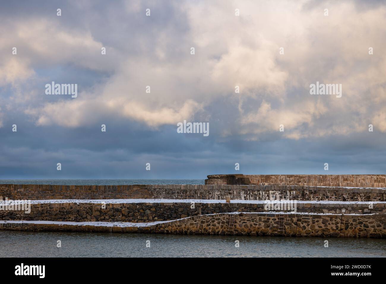 17 January 2024. Portsoy, Aberdeenshire, Scotland. This is Portsoy harbour following snow storms and a stormy sky. This was where the end of Peaky Bli Stock Photo