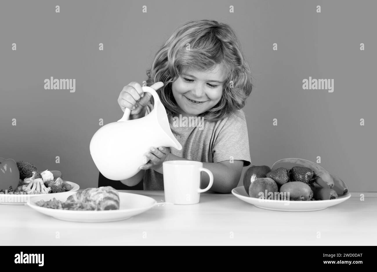 Child drink dairy milk. Kid having a breakfastand pouring milk. Healthy ...