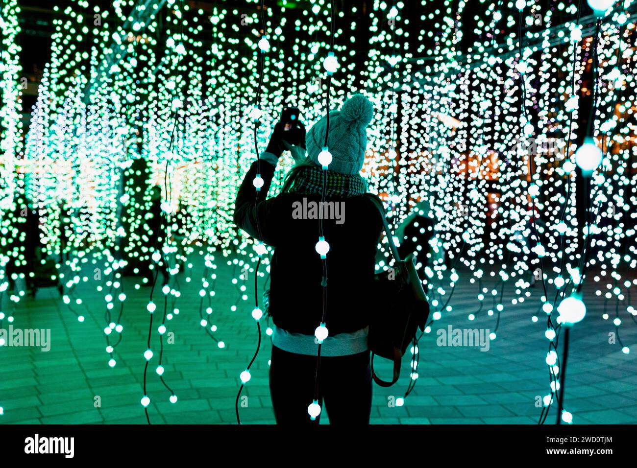 London, UK. 17th Jan, 2024. People are seen interacting with the light