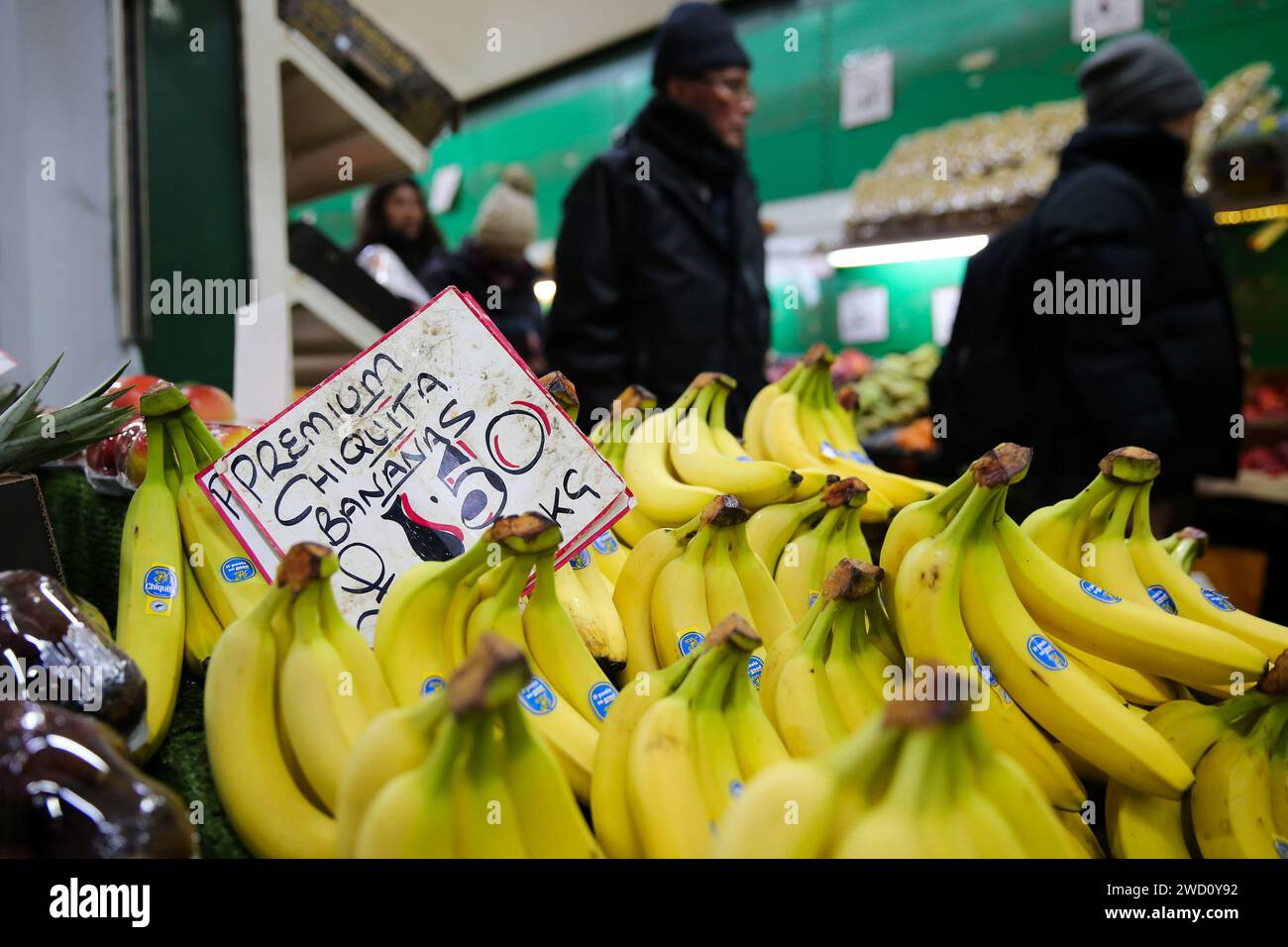 London, UK. 18th Jan, 2024. People purchase fruit in a shop in London