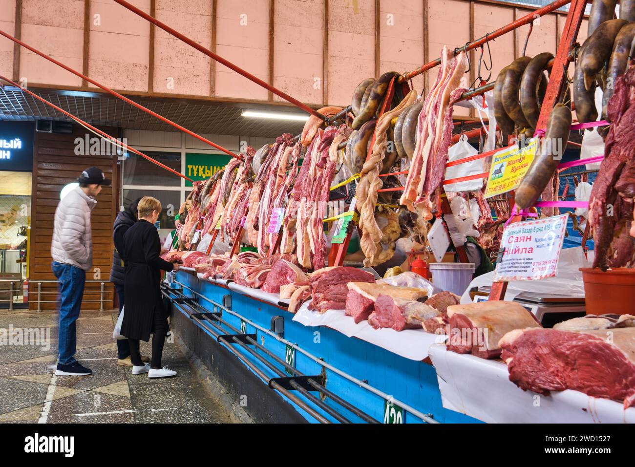 A view of the meat, butcher section, many vendors, stalls selling horse meat and horse sausages
