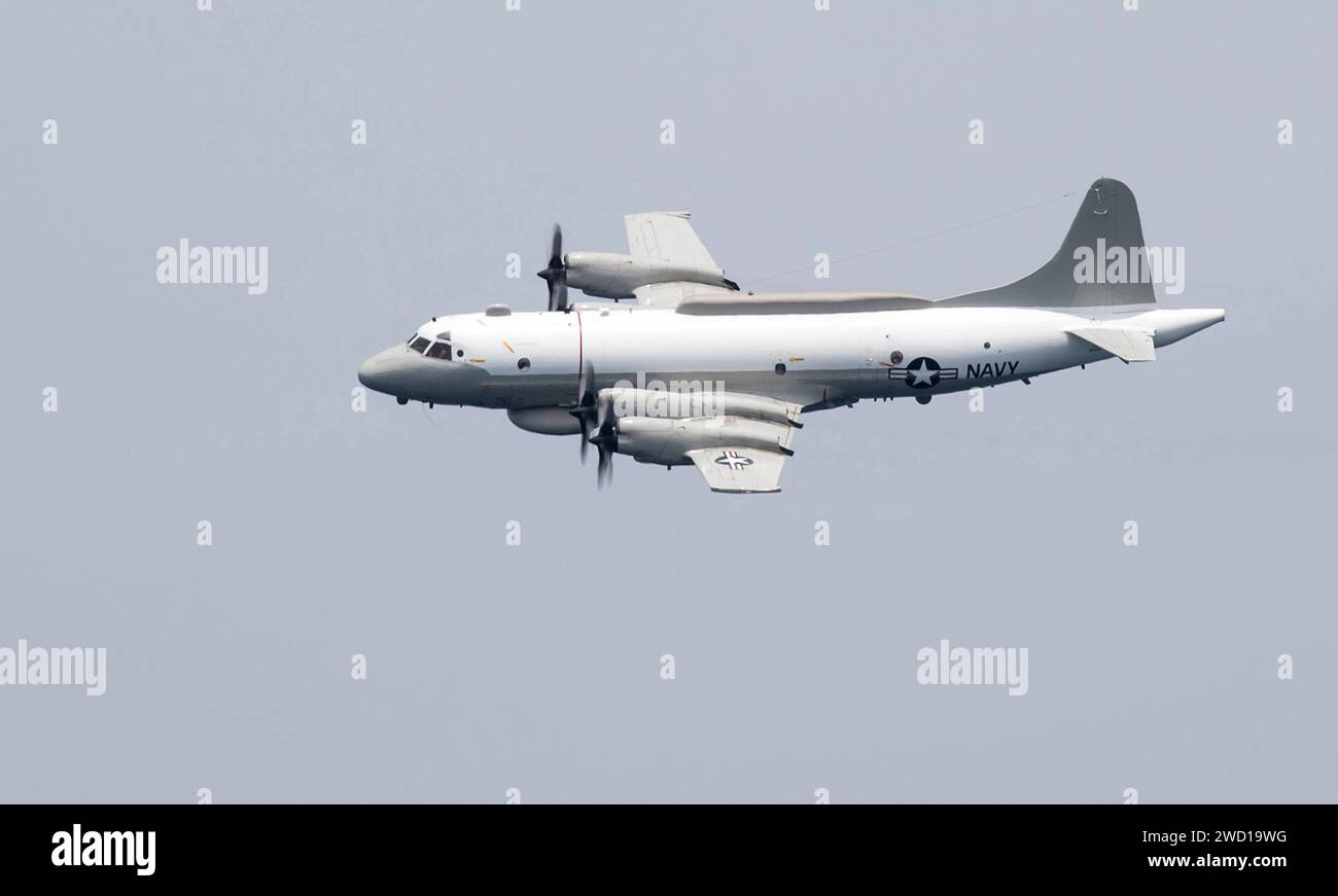 An EP-3E Aries performs a flyby over the Arabian Gulf. Stock Photo