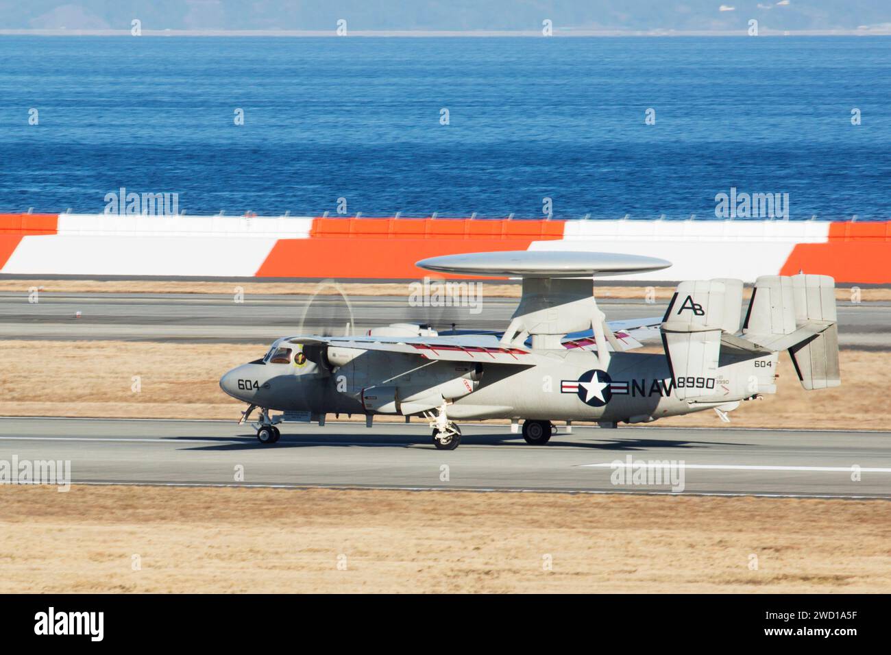 An E-2D Advanced Hawkeye taxis down the runway. Stock Photo