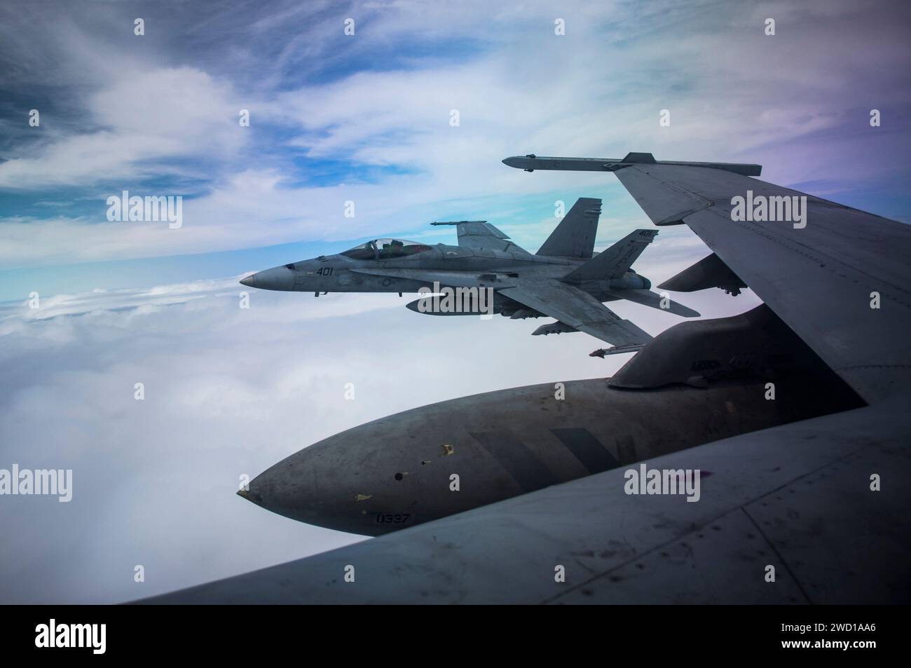 An F/A-18C Hornet flies alongside an F/A-18F Super Hornet. Stock Photo
