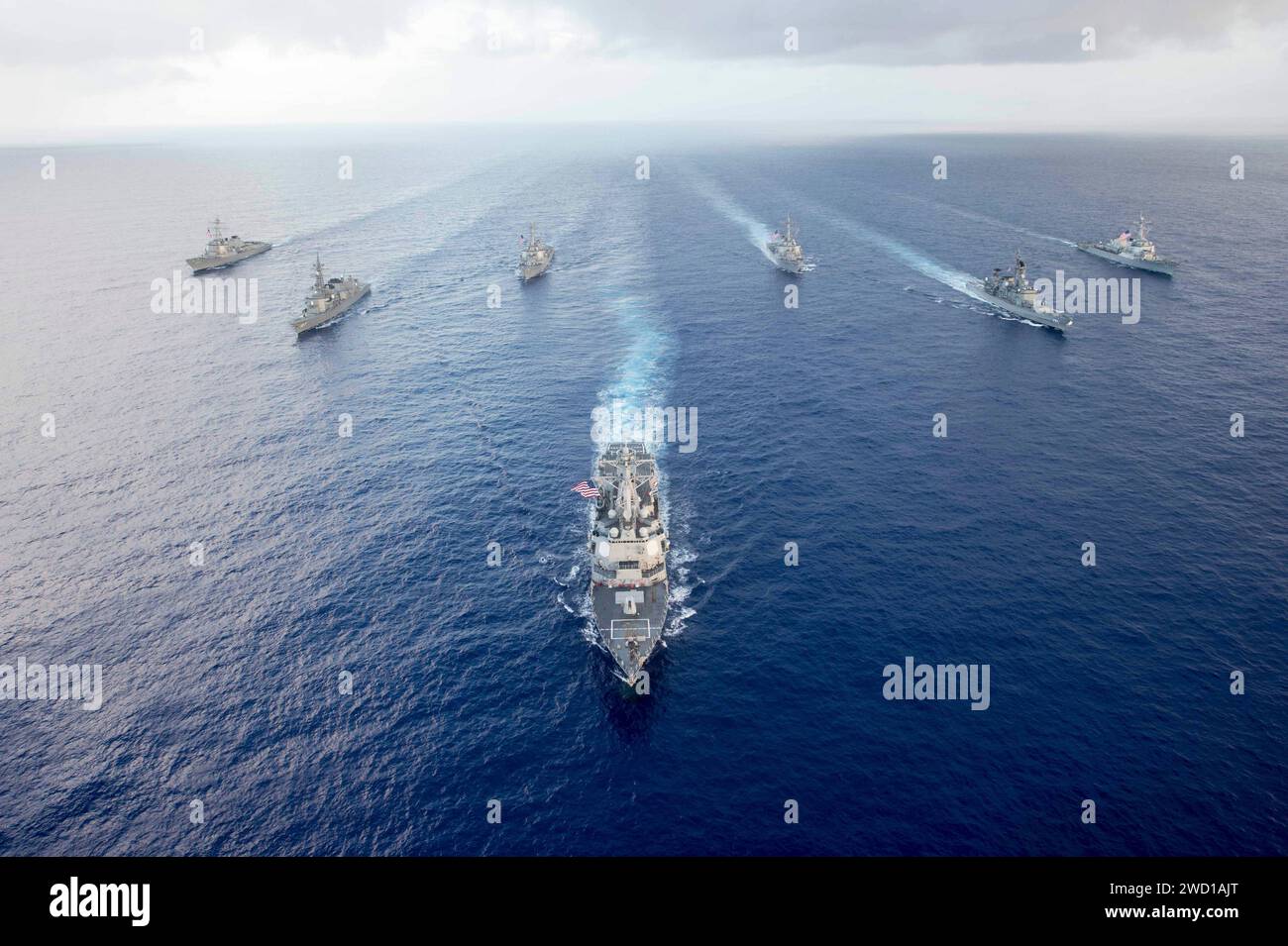 USS Mustin leads U.S. Navy and Japan Maritime Self-Defense Force ships in formation. Stock Photo