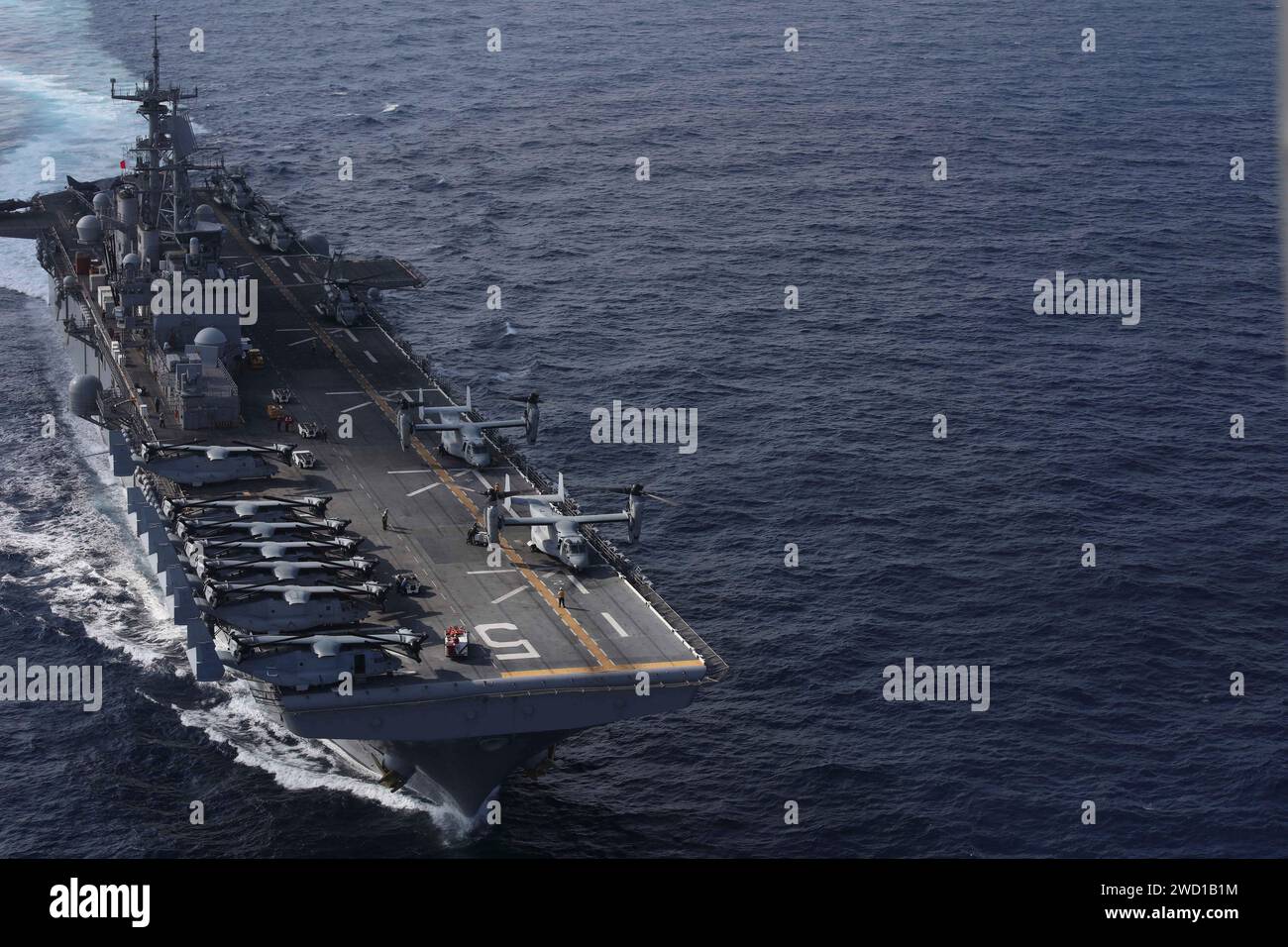 The amphibious assault ship USS Bataan with MV-22B Ospreys and CH-53E Super Stallions on flight deck. Stock Photo
