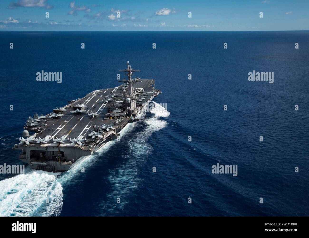 The Nimitz-class aircraft carrier USS Carl Vinson transits the Philippine Sea. Stock Photo