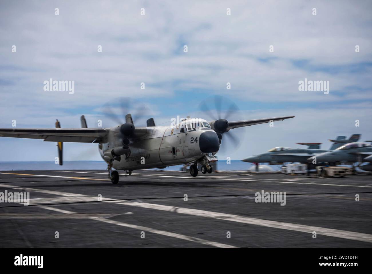 A C-2A Greyhound lands on the flight deck of USS Theodore Roosevelt. Stock Photo