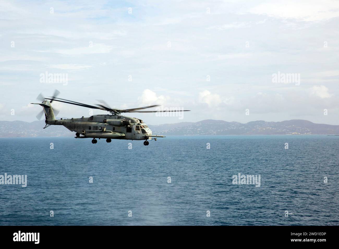 A U.S Marine Corps CH-53E Super Stallion helicopter flying over the Caribbean Sea. Stock Photo