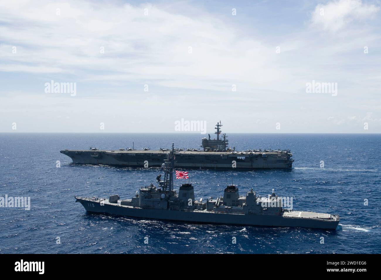 The Japanese Maritime Self-Defense Force ship JS Sazanami is underway alongside USS Ronald Reagan. Stock Photo