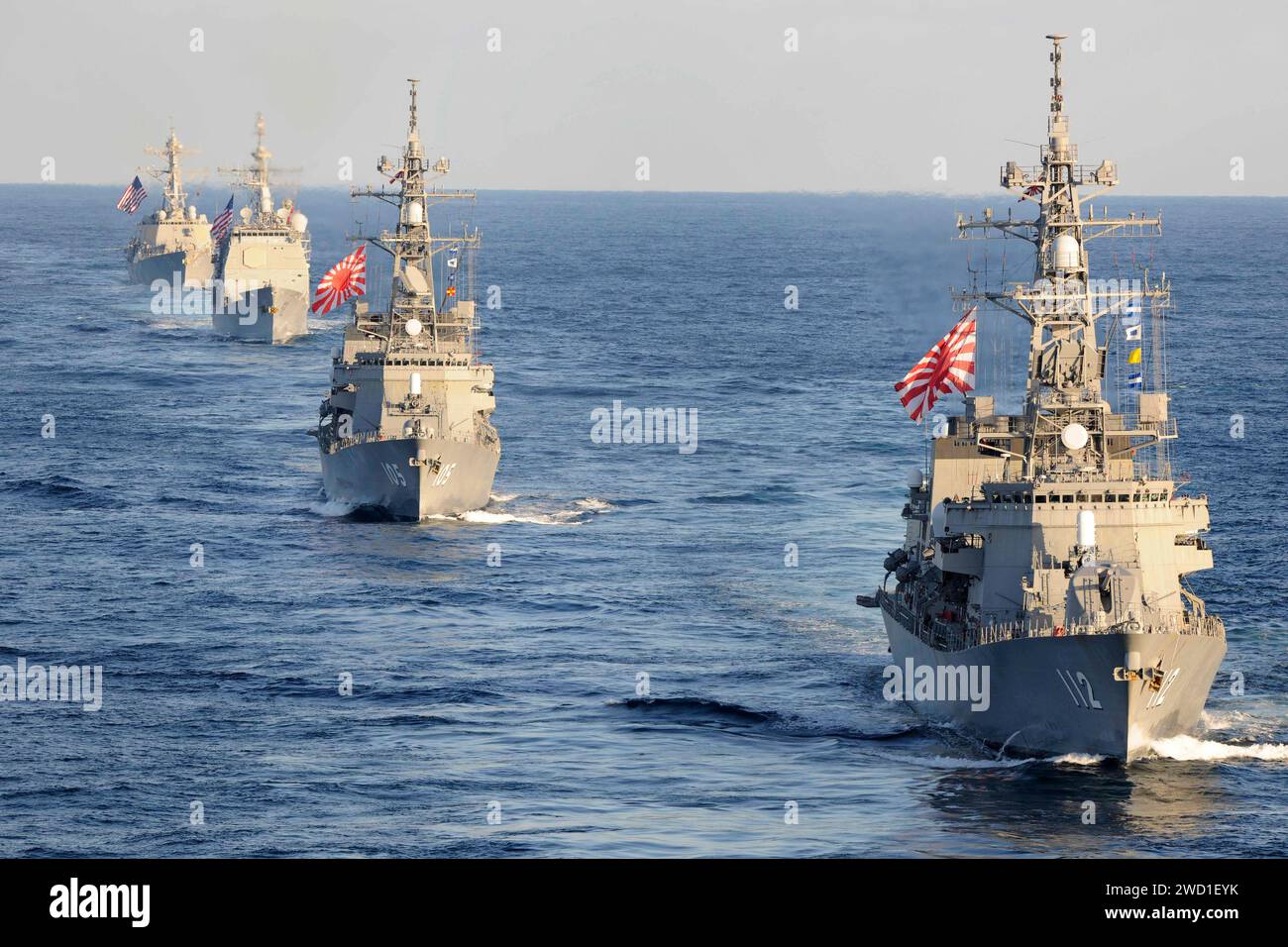 Japanese Navy and U.S. Navy ships transit the Western Pacific Ocean in formation. Stock Photo