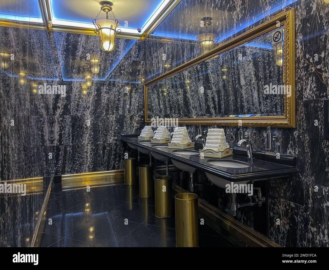 Luxury black marble bathroom with gold fixtures and large mirror ...