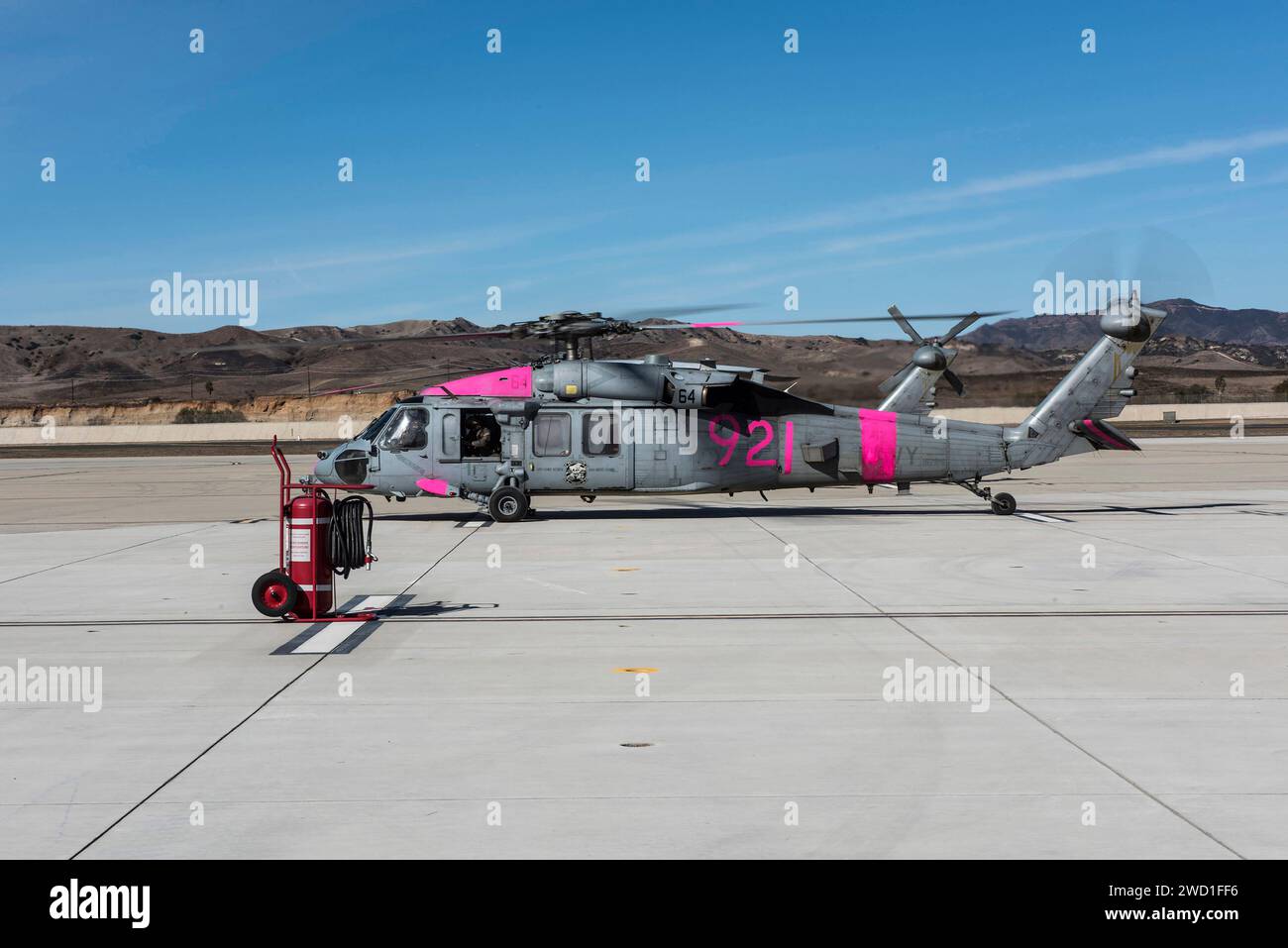 An MH-60S Sea Hawk helicopter is prepared for flight to assist in fighting California fires. Stock Photo