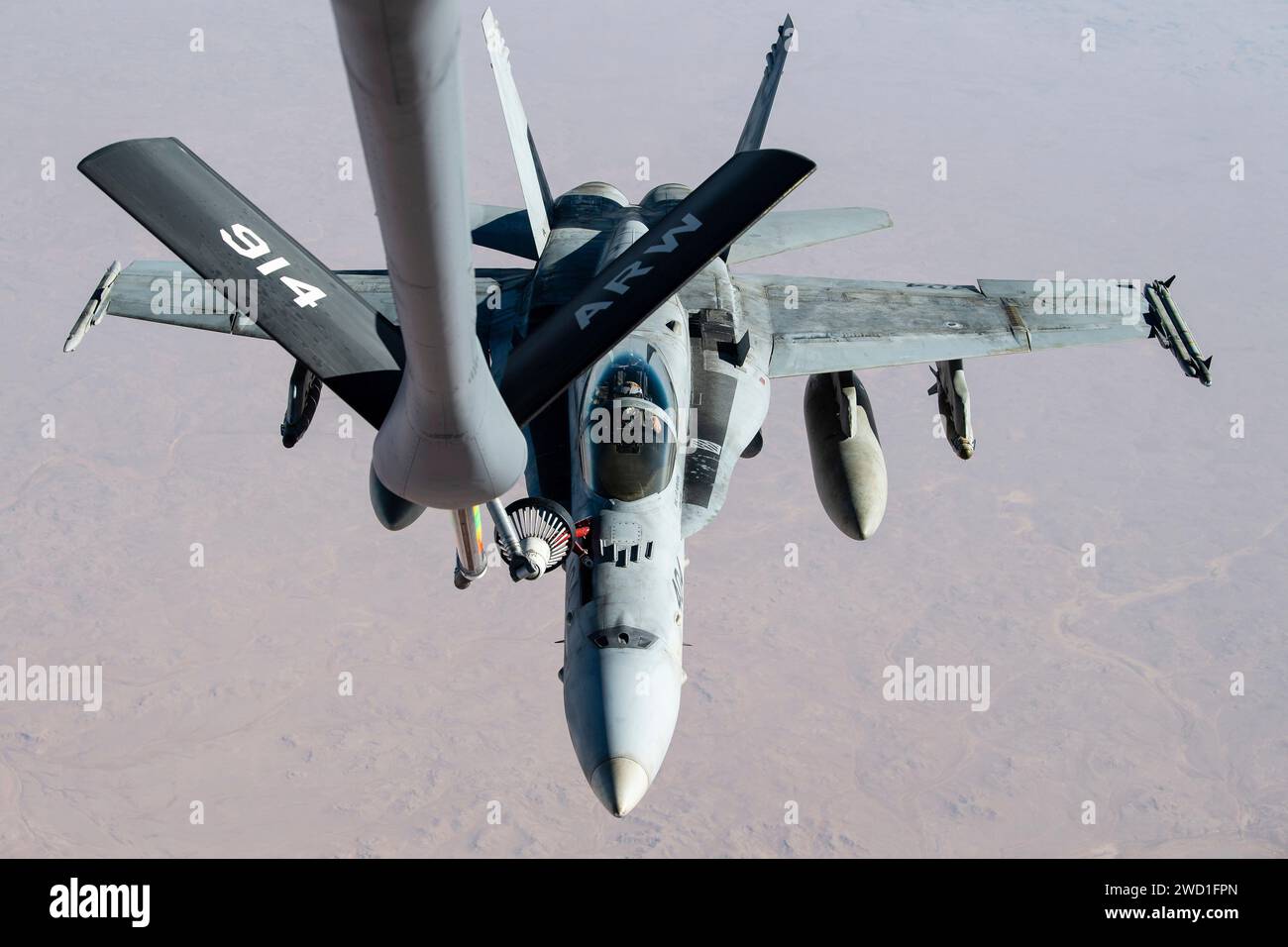 A U.S. Marine Corps F/A-18C Hornet receives fuel during a mission. Stock Photo