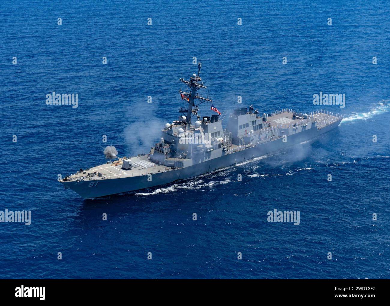 Guided-missile destroyer USS Winston S. Churchill fires its Mark 45 5-inch gun. Stock Photo
