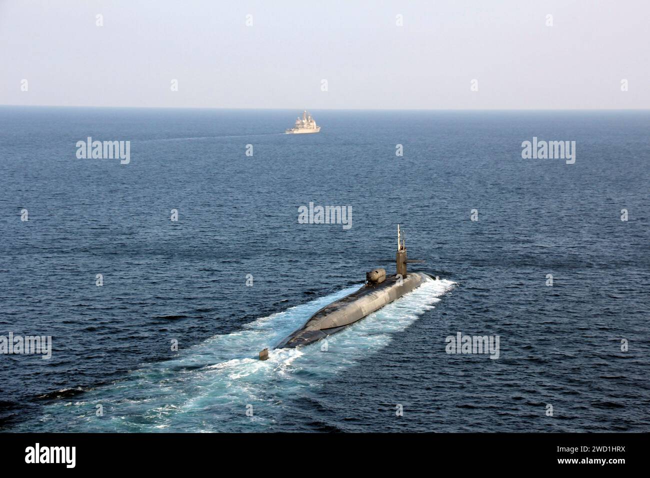 Guided-missile submarine USS Georgia transits the Strait of Hormuz with USS Port Royal. Stock Photo