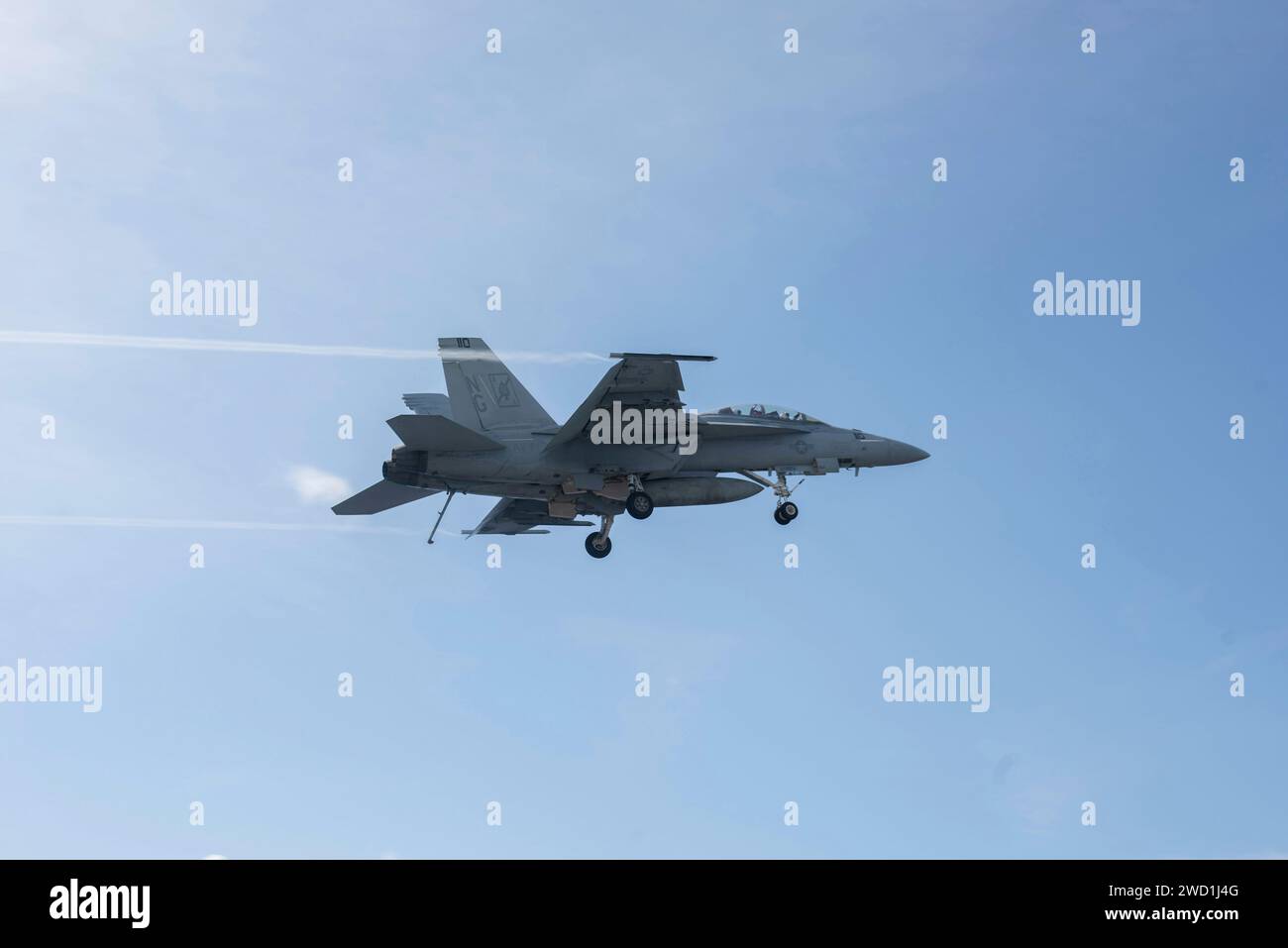 An F/A-18F Super Hornet flies over the South China Sea. Stock Photo