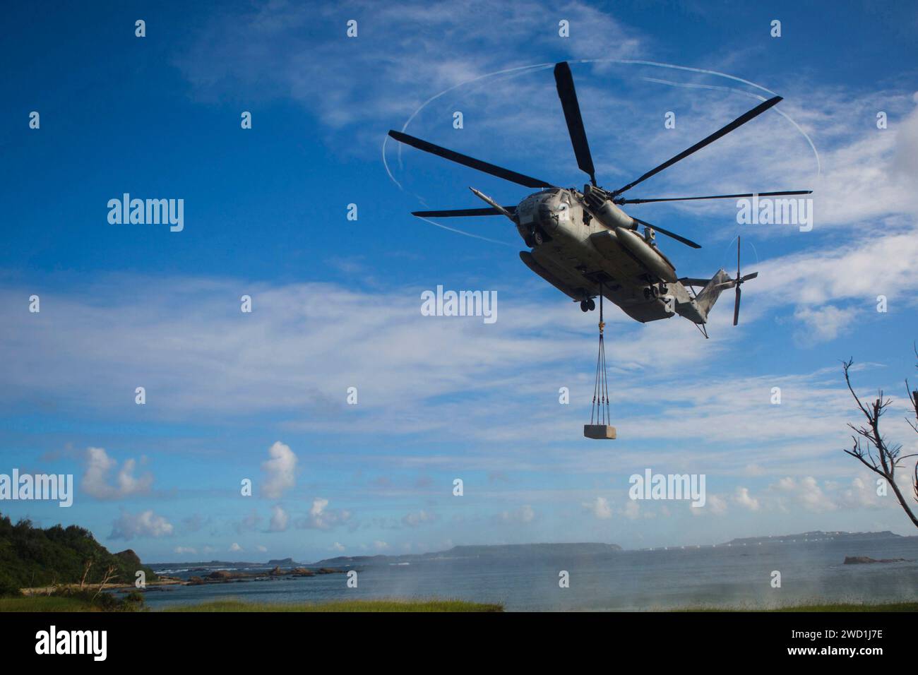A U.S. Marine Corps CH-53E Super Stallion hovers over a landing zone at Camp Hansen, Okinawa, Japan. Stock Photo