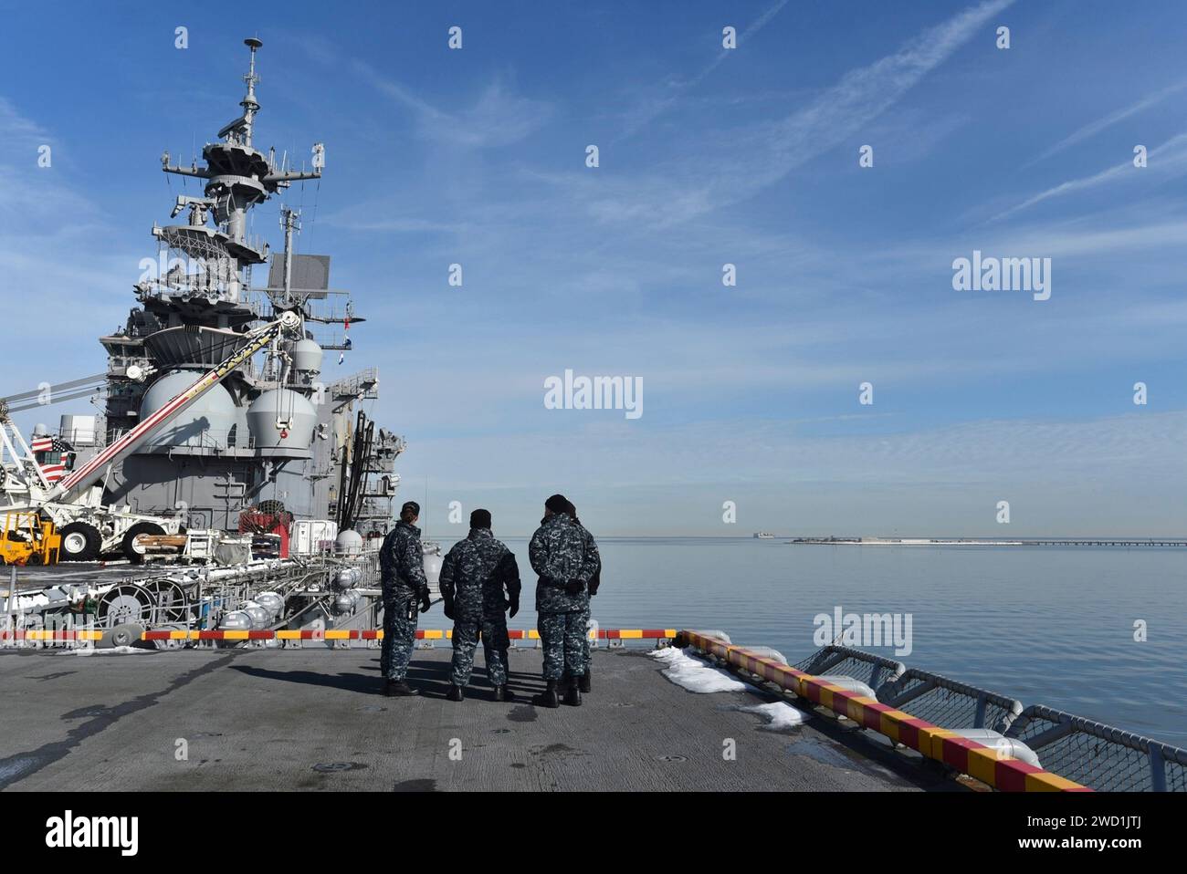 Sailors aboard USS Bataan watch as the ship prepares to cross over the Hampton Roads Bridge Tunnel for a training exercise. Stock Photo