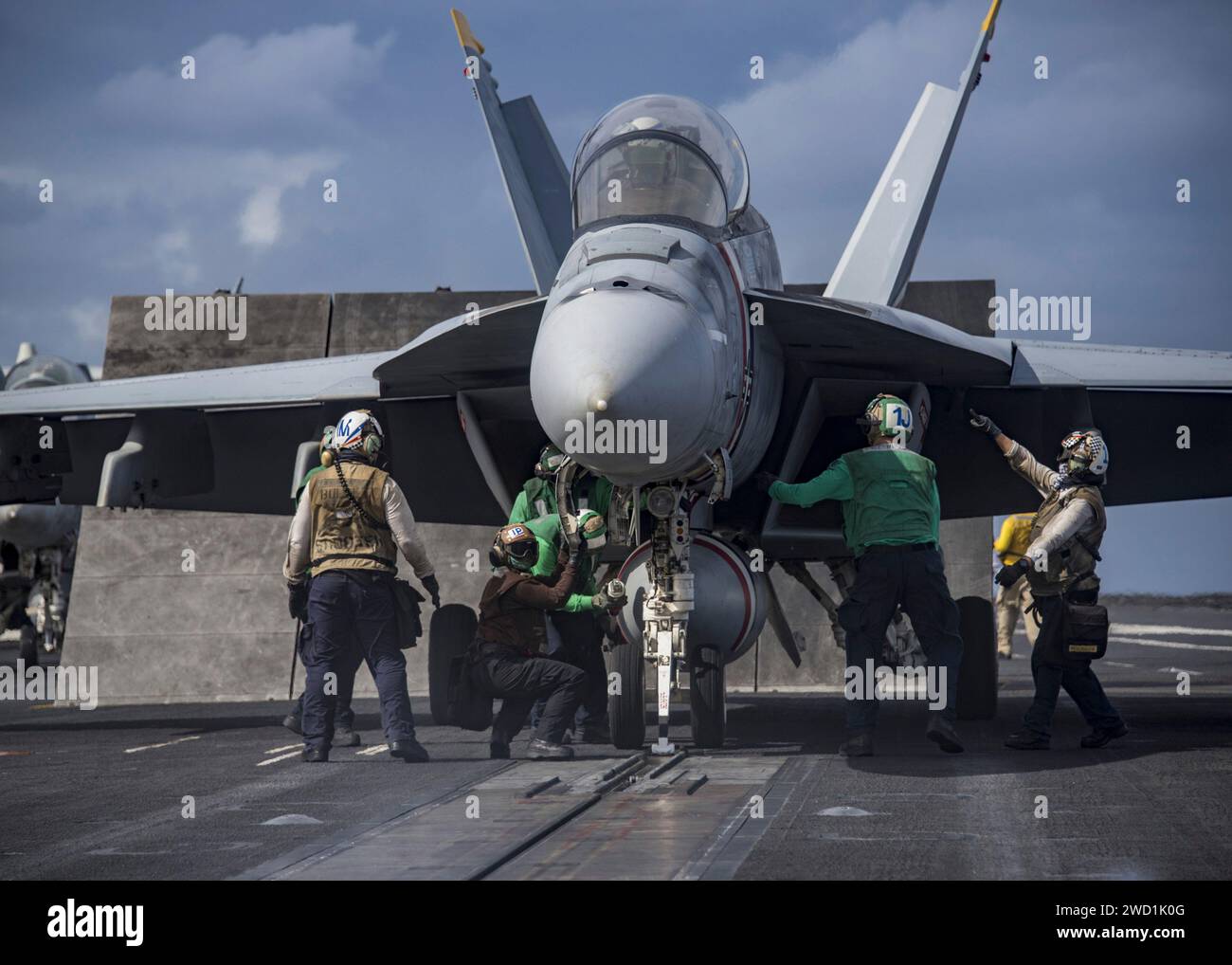 Sailors prepare an F/A-18F Super Hornet for take-off from USS Carl Vinson. Stock Photo