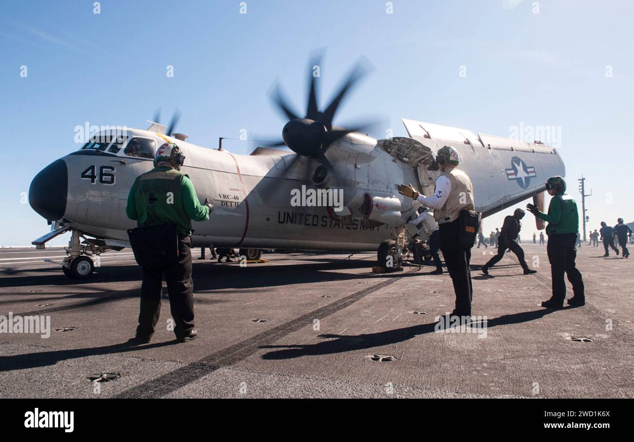 Sailors direct a C-2A Greyhound aboard the aircraft carrier USS George H.W. Bush. Stock Photo