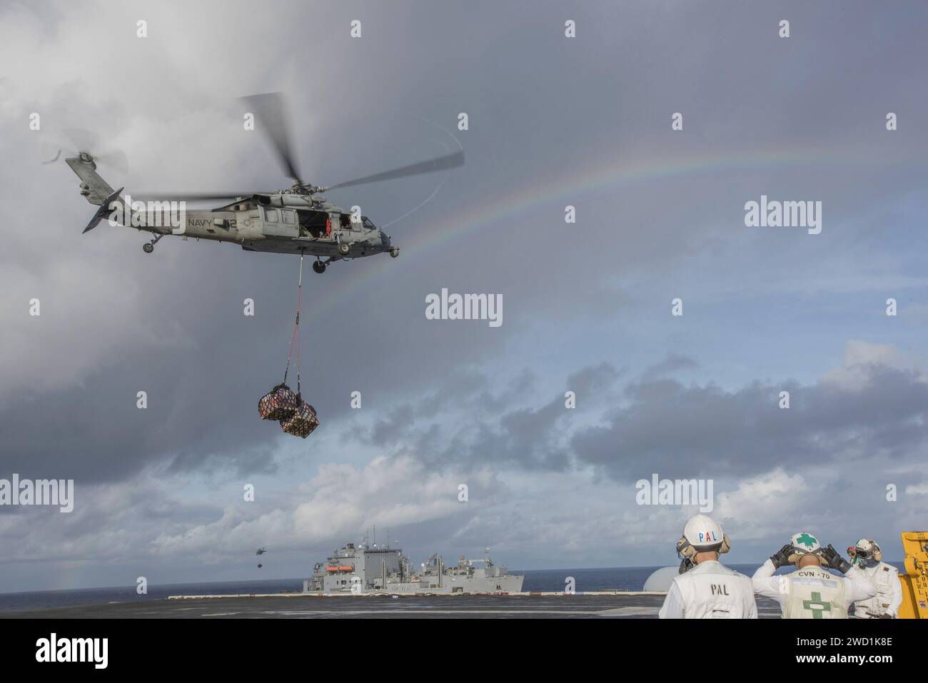 An MH-60 Sea Hawk participates in a vertical replenishment-at sea. Stock Photo