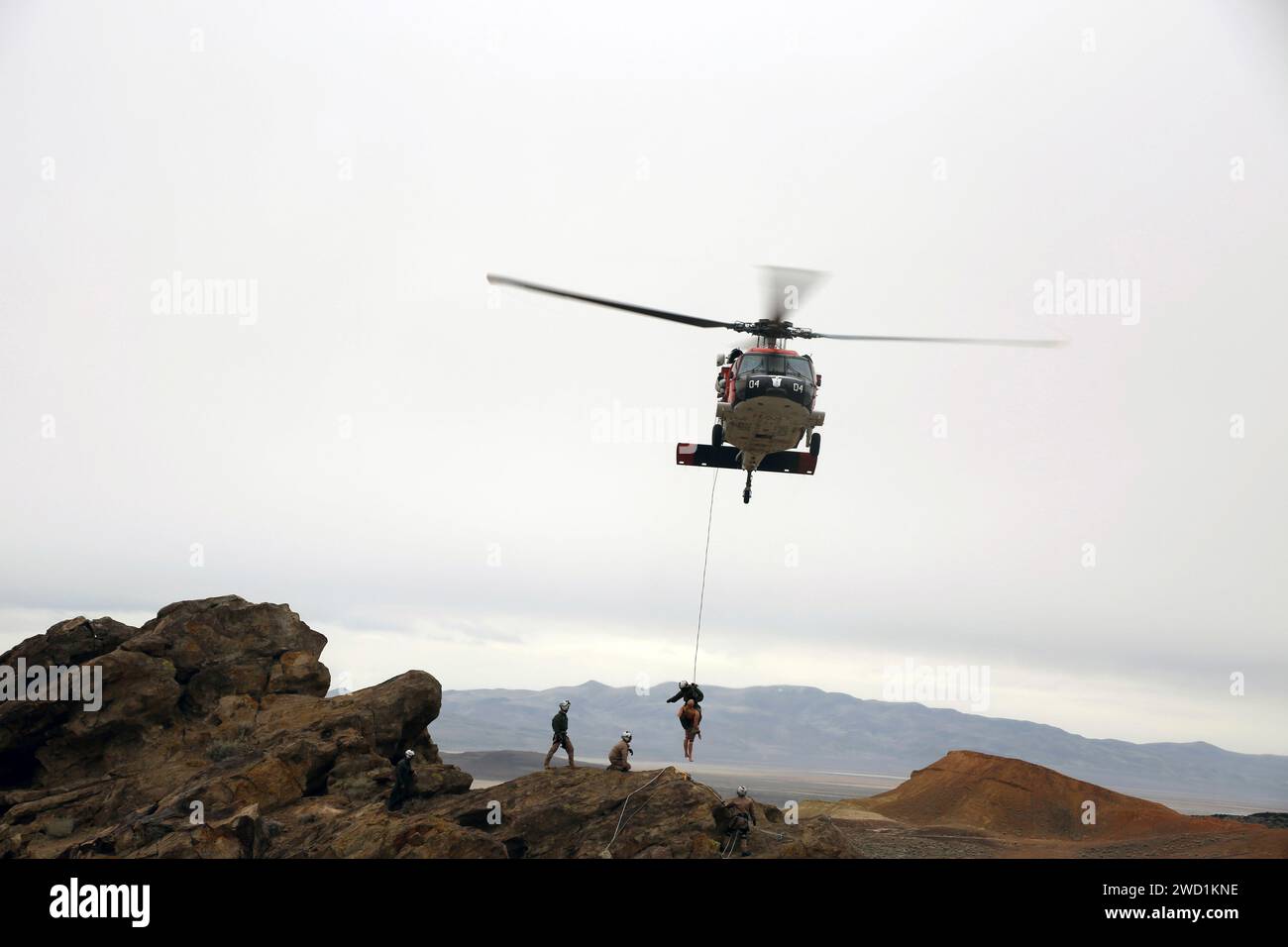 Sailors conduct cliff side rescue training exercises with an MH-60S Sea Hawk helicopter. Stock Photo