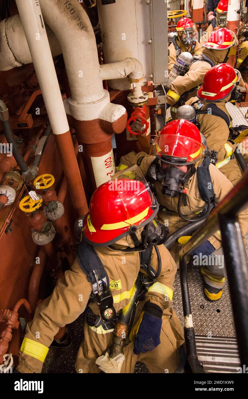 Sailors during a general quarters drill aboard the guided-missile destroyer USS Cole. Stock Photo