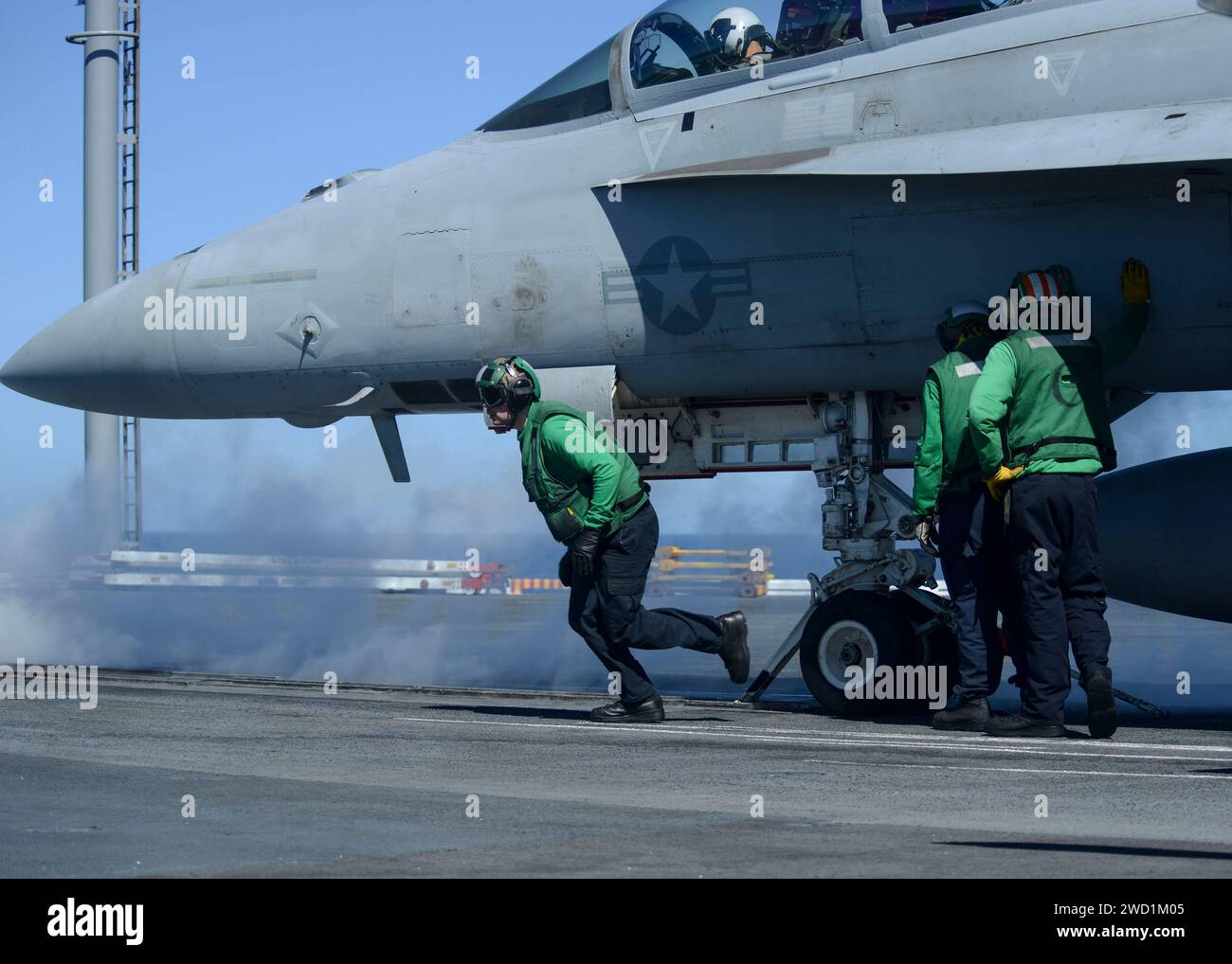 Sailors prepare an F/A-18F Super Hornet to be launched. Stock Photo