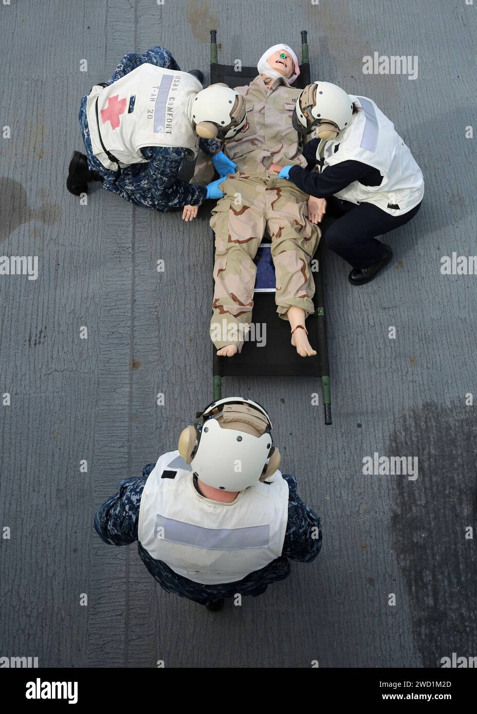Navy medical professionals perform diagnostics on a simulated casualty aboard USNS Comfort. Stock Photo