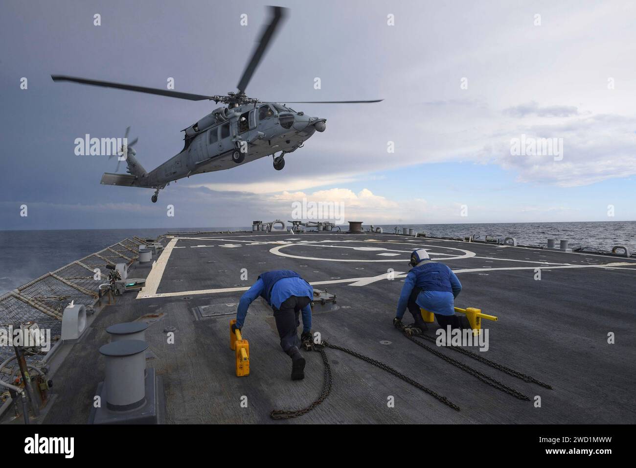 An MH-60S Sea Hawk prepares to land aboard the guided-missile destroyer USS Porter. Stock Photo