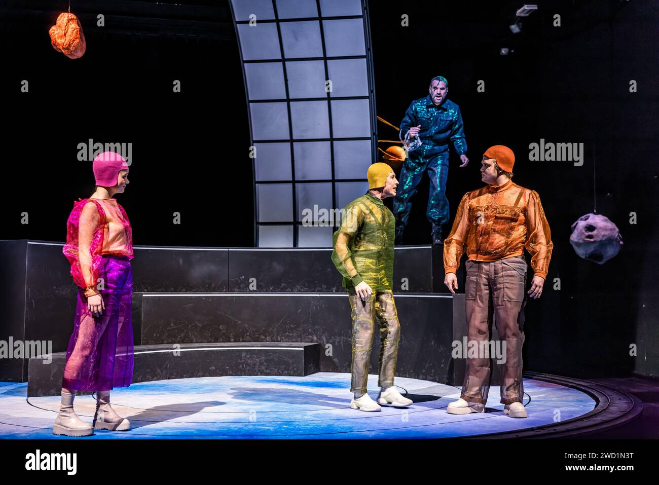 17 January 2024, Brandenburg, Cottbus: Actors Paula Aschmann (Hermia, l-r), Torben Appel (Lysander), Gunnar Golkowski (Puck) and Johannes Scheidweiler (Demetrius) stand on stage during a photo rehearsal for the play 'Rose and Rain, Sword and Wound'. Director Friederike Drews premieres a concentrated version of Shakespeare's 'A Midsummer Night's Dream' at the Cottbus Kammerbühne. Ev Benzing's stage design transforms the plot away from earthly crises and catastrophes and into the saving universe. Beat Fäh's 1989 Shakespeare adaptation ROSE AND RAIN, SWORD AND WOUND is based on Erich Fried's tran Stock Photo