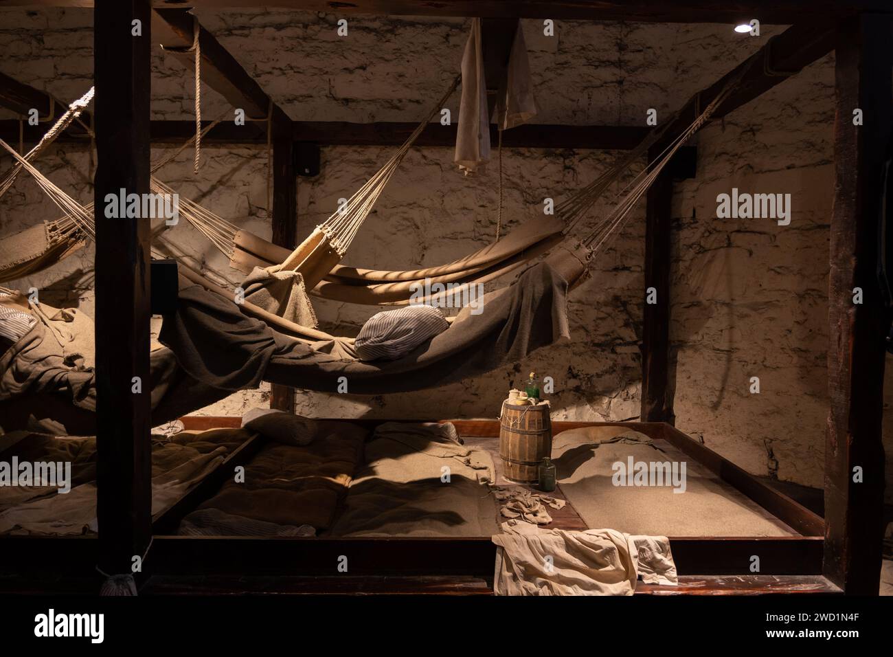 Prisons of War exhibition in Edinburgh Castle, Scotland, UK. Hammocks and bunk beds for pirates and prisoners of war in vaults below Crown Square in E Stock Photo